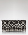 A bohemian Ikat motif is effortlessly glamorous on this beaded MOYNA clutch, styled in a slim fold-over silhouette.