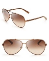 Fly to new style heights in these stylish Tory Burch aviator sunglasses, with snake arms that have the exotics trend wrapped up.