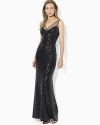 Sheer mesh details lend modern elegance to a sparkling sequin gown from Lauren Ralph Lauren.