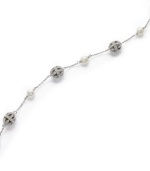 Luxury that lasts. This timeless Eliot Danori bracelet flaunts an exquisite mix of filigree crystal balls and simulated pearls (6 mm). Set in rhodium-plated mixed metal. Approximate length: 7-1/4 inches.