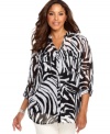 Pounce on a fierce look with Style&co.'s three-quarter sleeve plus size blouse, featuring an animal print.