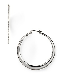 A jewel box treasure for now and forever, these graduated silver hoop earrings are dressed up in a rim of pristine pavé crystals. From Lauren Ralph Lauren.