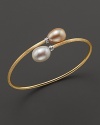 Gleaming peach and white freshwater pearls cap this 18K yellow gold bangle, from the Africa Pearl Collection.