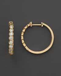 Diamonds set in 14K. yellow gold hoops.