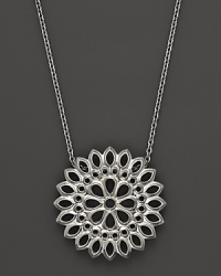 An applique pendant in sterling silver on a chain, designed by Paul Morelli.