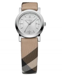 This Burberry timepiece features a Nova Check fabric strap and round stainless steel case. Silvertone engraved dial with tonal stick indices, logo and date window. Swiss made. Swiss movement. Water resistant to 50 meters. Two-year limited warranty. Style #BU1387