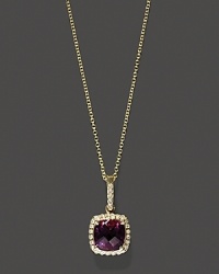 Diamonds frame a faceted amethyst, set in 14K yellow gold.