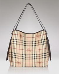 Give your look a classic finish with Burberry's leather-trimmed tote in the brand's iconic check.