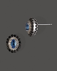 Diamonds and black diamonds circle faceted London blue topaz, set in 14K white gold.