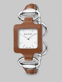 From the Gucci 1921 Collection. This stylish design has a white dial and a stainless steel and leather bangle. Swiss quartz movementWater resistant case to 3 ATMSquare stainless steel case with camel leather, 25mm (0.9) X 25mm (0.9) White dial with markersStainless steel and camel leather bangleMade in Switzerland 