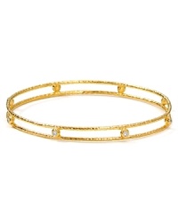 Delicately crafted from 18-karat gold plate and set with understated, clear-crystal stones, Melinda Maria's hammered bangle lends an elegant touch of sparkle.