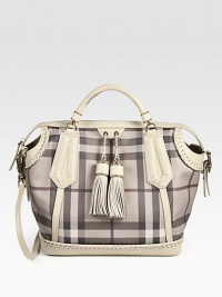 The iconic Burberry check defines this roomy shape of smooth PVC, finished with leather trim and super-chic tassels. Double leather top handles, 3¼ dropAdjustable detachable leather shoulder strap, 17-20½ dropTop zip closureOne inside zip pocketTwo inside open pocketsCotton lining13W X 12¾H X 7¾DMade in Italy