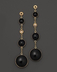 Sparkling diamonds highlight these drop earrings in bold black enamel and 18K yellow gold.