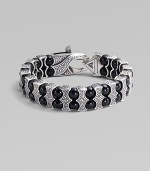 Architectural drama defines this bold bracelet, constructed of double rows of black onyx beads held by scalloped pillars of sterling silver. Black onyx Sterling silver Length, about 8¾ Lobster clasp Imported