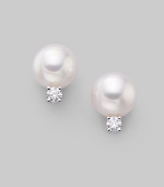 From the Akoya Collection. Classic white cultured pearl studs with sparkling diamond accents, set in 18k gold. 7mm white round cultured pearls Quality: A+ Diamonds, 0.10 tcw 18k white gold Post back Imported