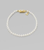 A strand of white cultured pearls with signature clasp closure.4mm white cultured pearls 18K yellow gold Length, about 7 Minuette clasp closure Imported 