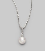 Simple and lovely, a white, round cultured Akoya pearl has a sparkling diamond accent, plus a chain and setting of 18k gold. 7mm white round cultured pearl Quality: A+ Diamond, 0.05 tcw 18k white gold Length, about 18 Spring ring clasp Imported