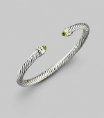 From the Color Classics Collection. The signature Yurman cable, in a graceful bangle capped with faceted peridot domes and accents of 14k gold. Peridot Sterling silver and 14k yellow gold Cable, 5mm Diameter, about 2¼ Imported