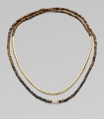 Beautifully textured, tiger's eye-inspired beads, radiant goldtone beads and a single rhinestone encrusted bead in a long strand, perfect for double-wrapping. Epoxy and brass beadsGlass stonesLength, about 24Slip-on styleImported 