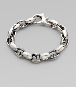 Alternating oval and thorn links in polished sterling silver. About 9½ long Lobster clasp Imported