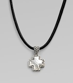 A simple leather cord holds a small cross pendant forged with a hammered finish in pure silver. Cord, 18-20 adjustable Lobster clasp closure Imported 