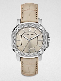 An dazzling timepiece with a diamond bezel on a brushed, grey stainless steel case and a luxurious alligator strap. Quartz movementWater resistant to 5 ATMOctagonal stainless steel case, 38mm (1.5) Diamond and screw accented bezel, 00 tcwNude dialBar and numeric hour markersSecond hand Trench alligator strapMade in Switzerland 