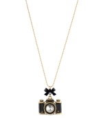 Picture perfect. A chic camera pendant adorns this unique necklace from Betsey Johnson. With a charming bow embellishment and sparkling crystal details, it's crafted in gold tone mixed metal. Approximate length: 30 inches + 3-inch extender. Approximate drop: 1-6/10 inches.