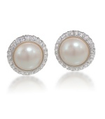 Timeless and tasteful. Carolee's cabochon button earrings epitomize classically chic style. Crafted in silver and gold tone mixed metal, they're embellished with imitation pearls surrounded by sparkling glass accents. Approximate diameter: 1/2 inch.