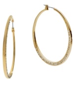 Don't be subtle, stand out! Michael Kors' shimmering hoop earrings feature a shiny gold tone mixed metal setting decorated at the bottom by sparkling crystals. Approximate diameter: 2 inches.