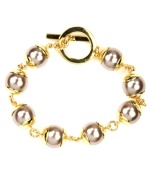 Elegance in an instant. This bracelet by AK Anne Klein features chic plastic pearl beads and toggle clasp. Crafted in gold tone mixed metal. Approximate length: 7-3/4 inches.