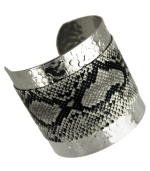 Slink into something fierce. GUESS adds sultry style with this cuff bracelet with a black and white snake print. Crafted from textured imitation rhodium silver tone mixed metal. Approximate diameter: 2-1/4 inches.