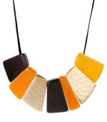 Pick a new palette for the season! This chic Kenneth Cole New York frontal necklace is composed of geometric gold-tone mixed metal discs with brown, yellow and orange beads. Sits on a brown leather cord. Approximate length: 17 inches + 3-inch extender. Approximate drop: 2 inches.