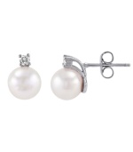 Crafted on the island of Mallorca, Spain, these lustrous man-made pearls (8 mm) shimmer with the addition of round-cut cubic zirconia accents. Stud earrings by Majorica set in sterling silver.