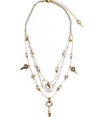 Simple and sweet. A dainty three-layer illusion necklace by Betsey Johnson features delicate chains decorated with acrylic pearls, crystal keys, and heart charms. Crafted in silver and gold tone mixed metal. Approximate length: 16 inches + 3-inch extender. Approximate drop: 3 inches.