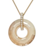 For a look that's got all the right curves. This elegant Swarovski pendant features an open-cut crystal circle with a gold tone mixed metal setting and chain. Bail accented with sparkling clear crystals. Approximate length: 15 inches. Approximate drop: 1-1/2 inches.