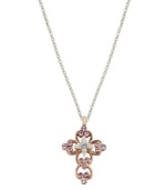 Express your faith with subtle, feminine flair. Vatican pendant features an intricate, scrolling cross highlighted with beautiful violet crystals. Setting and chain crafted in silver tone and rose gold tone mixed metal. Approximate length: 24 inches. Approximate drop: 1-1/4 inches.