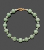 Simple and clean, this look is always in style. Bracelet features round jade beads (4 mm and 8 mm) with a 14k gold clasp. Approximate length: 7-1/2 inches.