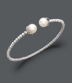 Add class to any look with polished pearls and a touch of shimmer. This sterling silver bangle bracelet features a unique beaded design that highlights two cultured freshwater pearls (8-1/2-9 mm) at the ends. Approximate diameter: 2-1/2 inches.