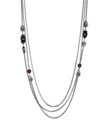 Long story. From the Crystal Elegance Collection, T Tahari's triple strand long necklace features subtle embellishment in the form of red and black crystal accents. Crafted in hematite tone mixed metal, it's nickel free for sensitive skin. Approximate length: 30 inches + 3-inch extender.