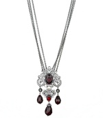 Spectacular style. T Tahari's Crystal Elegance Collection showcases majestic design, as exemplified by this faceted red crystal three strand necklace. Crafted in hematite tone mixed metal, it's enhanced by sparkling black crystal accents. Nickel free for sensitive skin. Approximate length: 32 inches + 4-inch extender. Approximate drop: 4 inches.