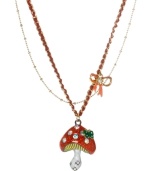 Summer charm comes natural with this Betsey Johnson pendant necklace. Combines a crystal-accented red and white enamel mushroom and crystal-accented pink bow. Crafted in gold tone mixed metal intertwined with red thread. Approximate length: 16 inches + 3-inch extender. Approximate drop: 1-3/4 inches.