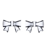 Chic bows in contrasting colors. Betsey Johnson earrings feature flirty bows in black and white enamel. Set in mixed metal. Approximate diameter: 1 inch.