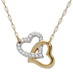 Heart of gold: Add a sentimental accent to your look with Swarovski's interlocking crystal heart pendant. Crafted in gold tone mixed metal. Approximate length: 15 inches. Approximate drop: 1 inch.