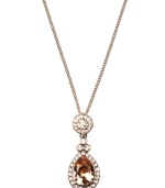 Add a regal touch to any look in Givenchy's silk teardrop pendant. Crafted from brown gold tone mixed metal, necklace incorporates shimmering topaz and clear-colored crystals. Approximate length: 16 inches + 2-inch extender. Approximate drop: 1-1/2 inches.