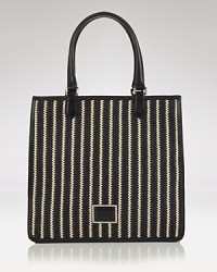 Take MARC BY MARC JACOBS' signature offbeat chic to the beach with this striped tote. In resort ready straw, this beachy bag lives to enliven a gauzy tunic and flat sandals.