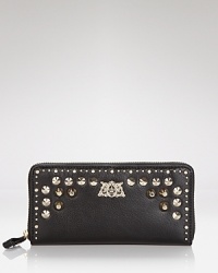 Tough meets on-the-go-chic in this Juicy Couture leather wallet, which works a hard-hitting vibe with studded detailing.