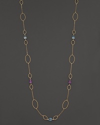 Faceted oval amethyst and blue topaz add rich sparkle to 14K yellow gold. By Nancy B.