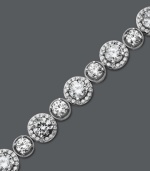 Enlighten your look with a little Arabella. This glamorous tennis bracelet features a unique circular design that highlights dozens of round-cut Swarovski zirconias (22-9/10 ct. t.w.). Crafted in sterling silver. Approximate length: 7 inches.