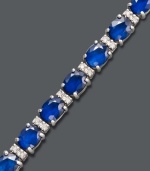 Stun them with sapphire. Effy Collection's head-turning tennis bracelet highlights oval-cut sapphires (12 ct. t.w.) and sparkling round-cut diamonds (1/4 ct. t.w.) set in 14k white gold. Features a figure 8 clasp for secure wear. Approximate length: 7-1/2 inches. Approximate width: 1/8 inch.