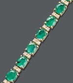 Enviable style. Effy Collection's stunning tennis bracelet features oval-cut emeralds (9-1/3 ct. t.w.) and round-cut diamonds (1/4 ct. t.w.). Set in 14k gold. Features a figure 8 safety clasp for secure wear. Approximate length: 7-1/2 inches. Approximate width: 1/8 inch.